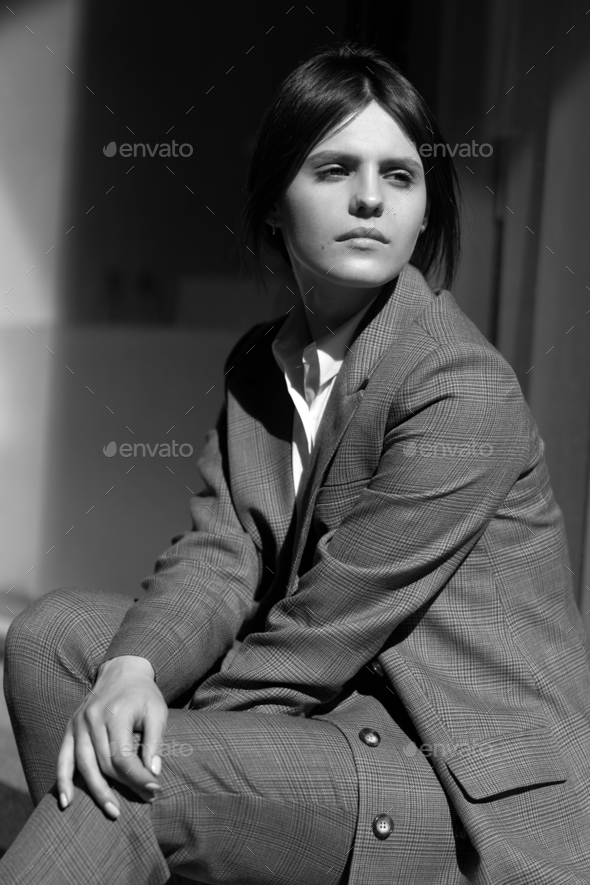 High fashion portrait of young elegant woman in brown suit walk on the